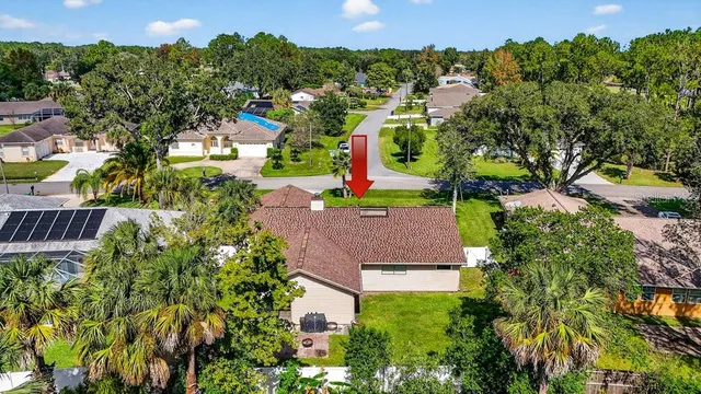 an aerial view of a house with a yard