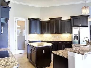 3179 Drummond Way Rockledge, FL 32955 - Photo 13 of 23 a kitchen with stainless steel appliances granite countertop a sink stove and cabinets