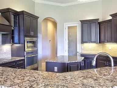 3179 Drummond Way Rockledge, FL 32955 - Photo 14 of 23 a view of kitchen with granite countertop wooden cabinets and stainless steel appliances