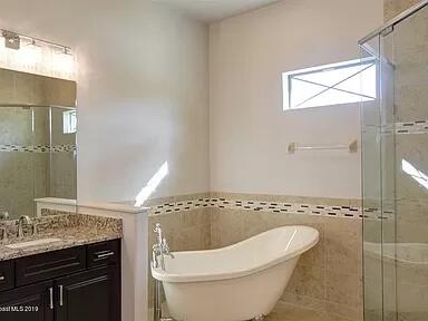 3179 Drummond Way Rockledge, FL 32955 - Photo 18 of 23 a bathroom with a granite countertop sink a toilet and a mirror
