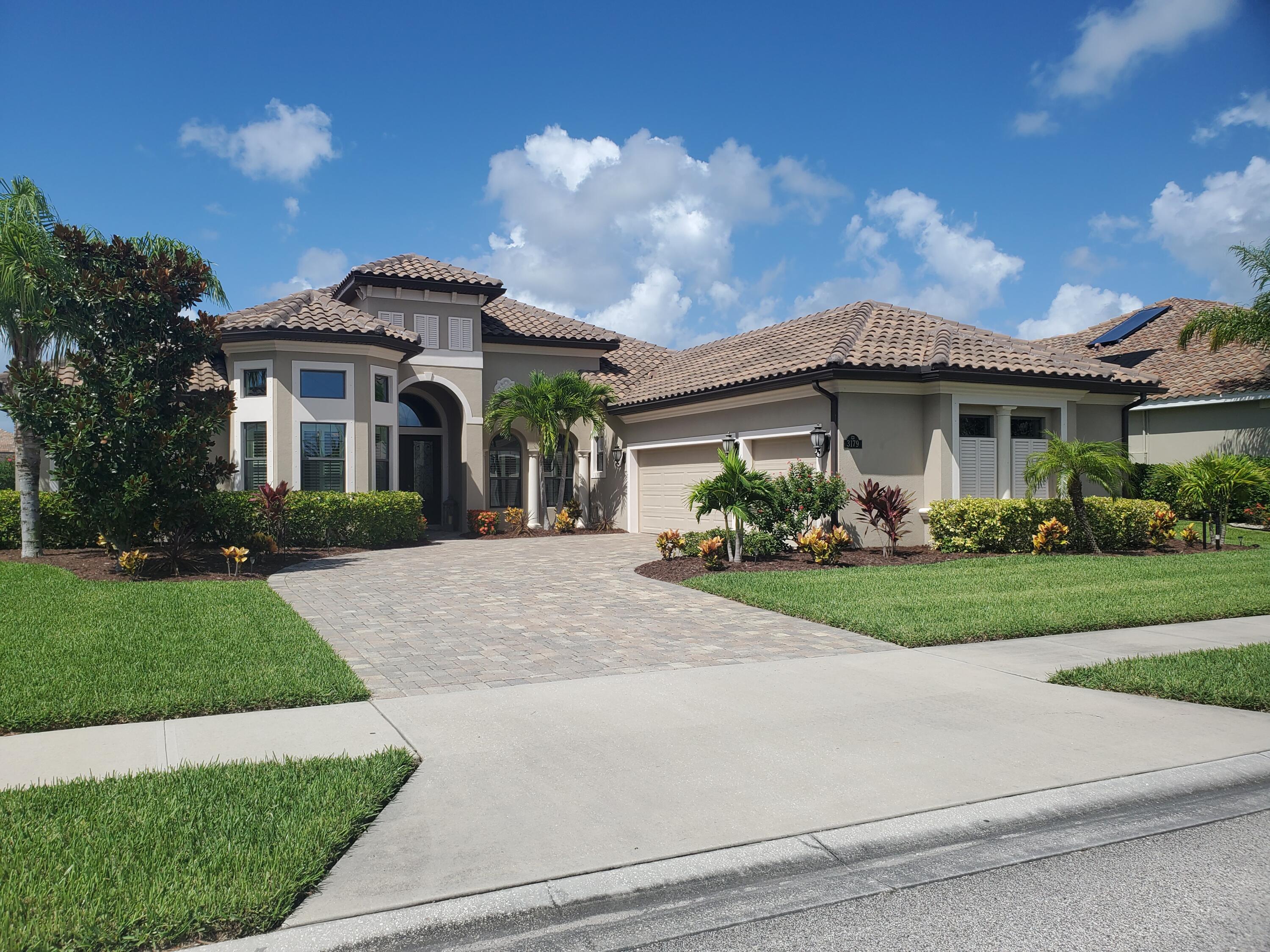 3179 Drummond Way Rockledge, FL 32955 - Photo 2 of 23 a front view of a house with garden