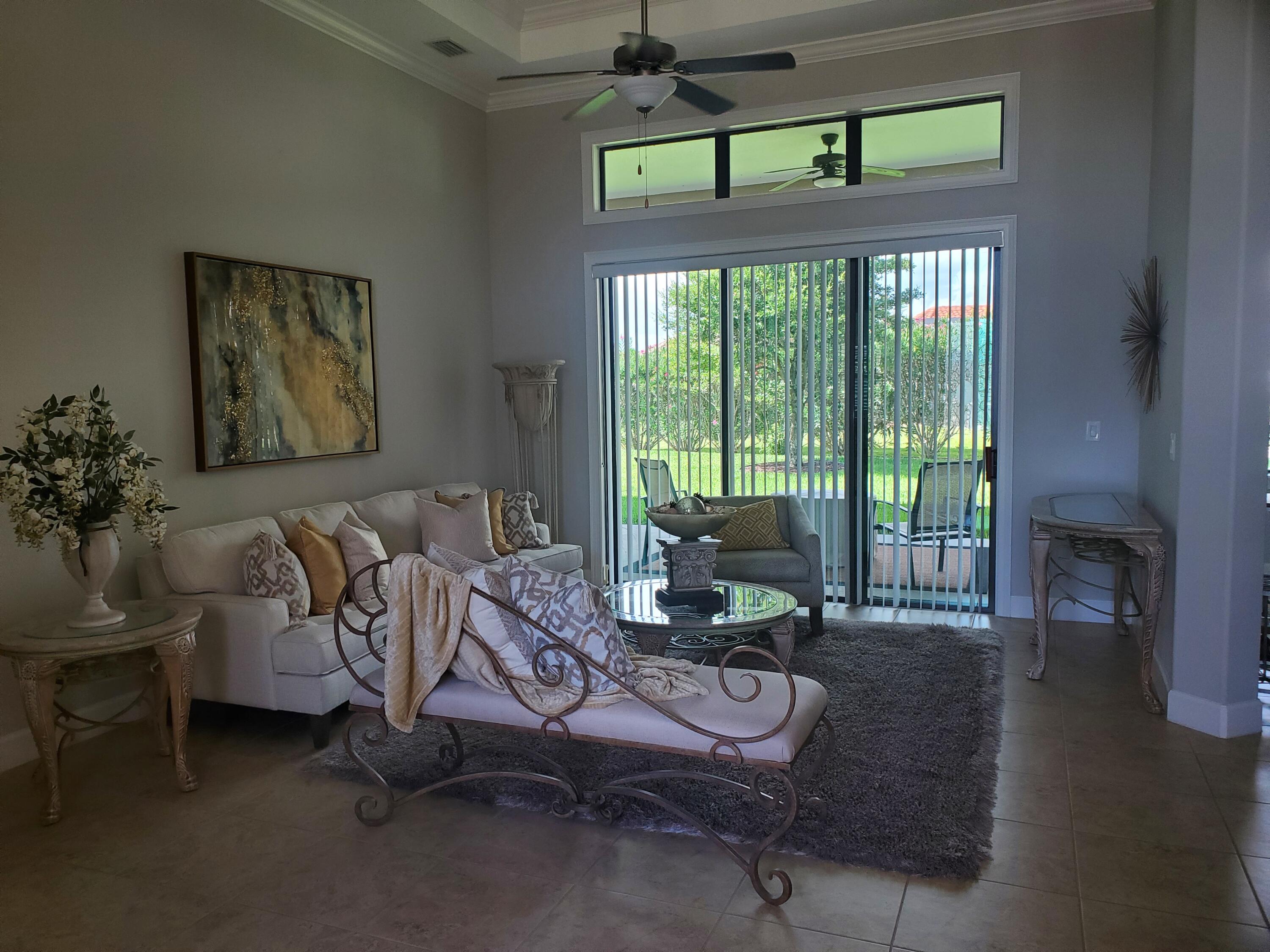 3179 Drummond Way Rockledge, FL 32955 - Photo 5 of 23 a living room with furniture and a floor to ceiling window