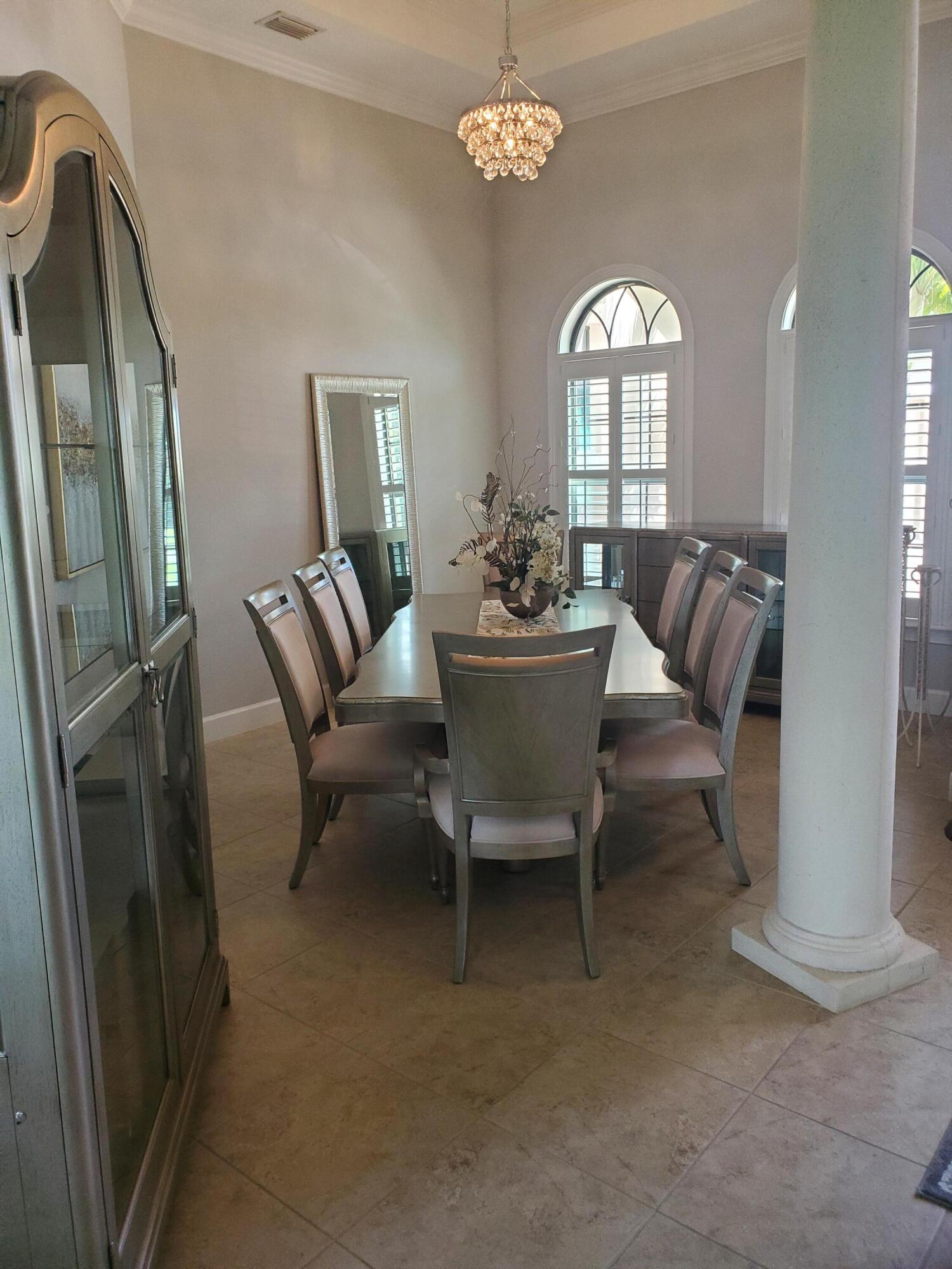 3179 Drummond Way Rockledge, FL 32955 - Photo 7 of 23 a living room with furniture a fireplace and a chandelier