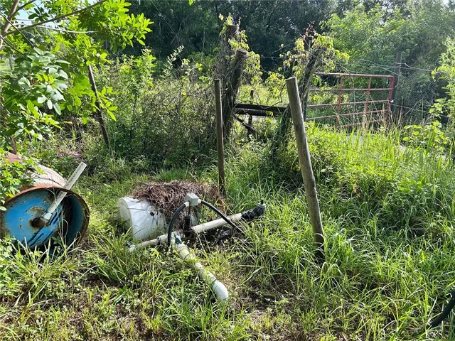 a backyard of a house with lots of green space and lake view