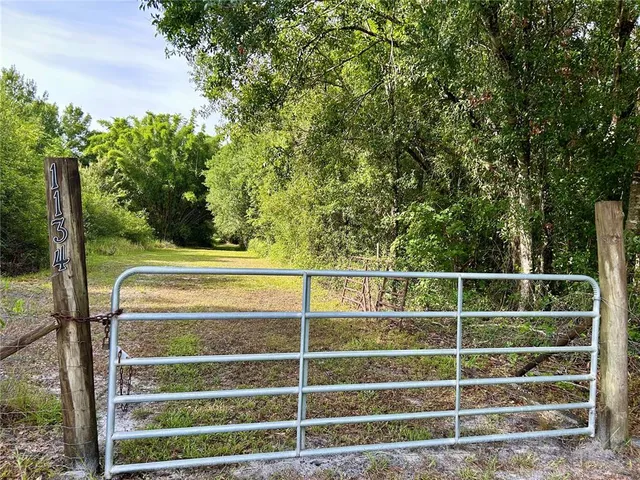 a view of a balcony with a floor to ceiling window and wooden fence