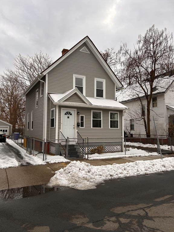 73 Lebanon Street Springfield, MA 01109 - Photo 3 of 19 a view of a white house with a large tree next to a yard