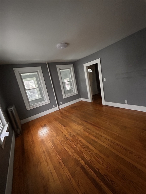 73 Lebanon Street Springfield, MA 01109 - Photo 8 of 19 an empty room with wooden floor and windows