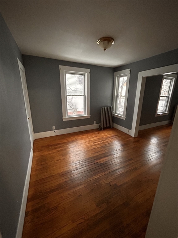 73 Lebanon Street Springfield, MA 01109 - Photo 9 of 19 a view of an empty room with wooden floor and a window