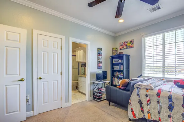 a living room with furniture kitchen view and a chandelier