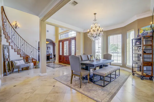 a living room with furniture a fireplace and a chandelier