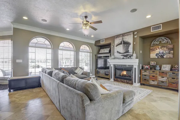 a dining room with furniture a chandelier and window
