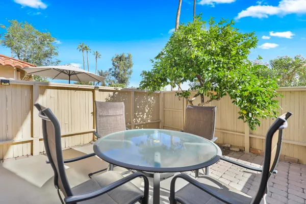 a view of a chairs and table in the patio
