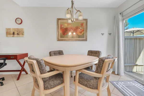 a view of a dining room with furniture and a window