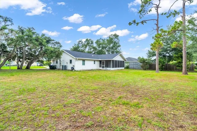 a view of an house with backyard space and swimming pool