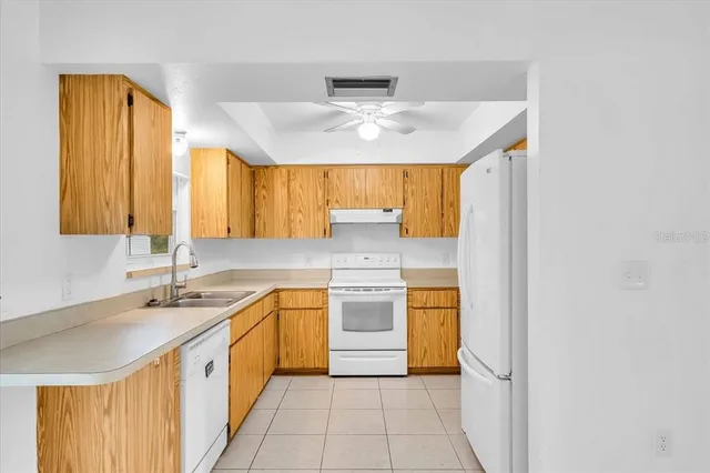 a kitchen with a sink cabinets and window