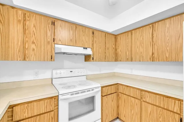 a utility room with cabinets washer and dryer