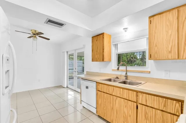 a kitchen with a sink window and cabinets