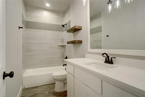 a bathroom with a sink a toilet and a tub