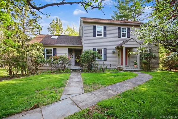 a front view of a house with a garden