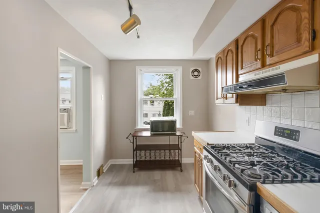 a kitchen with a stove and a window