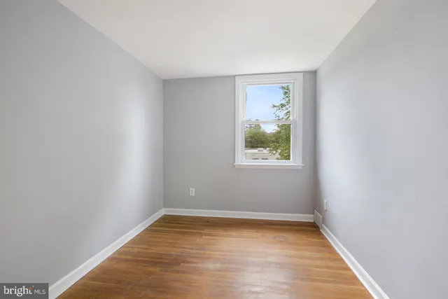 a view of room with window and hardwood floor