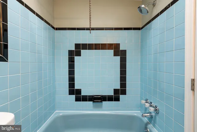 a bathroom with a bathtub and shower
