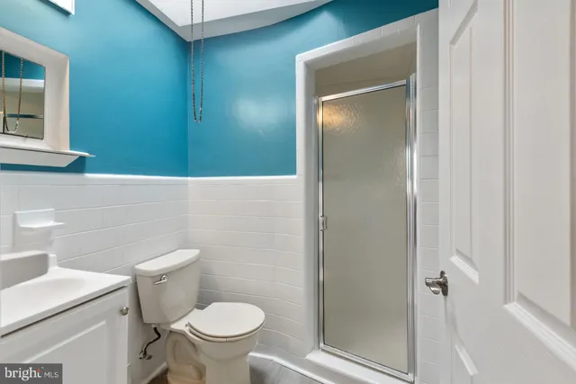 a white toilet sitting next to a bathroom sink