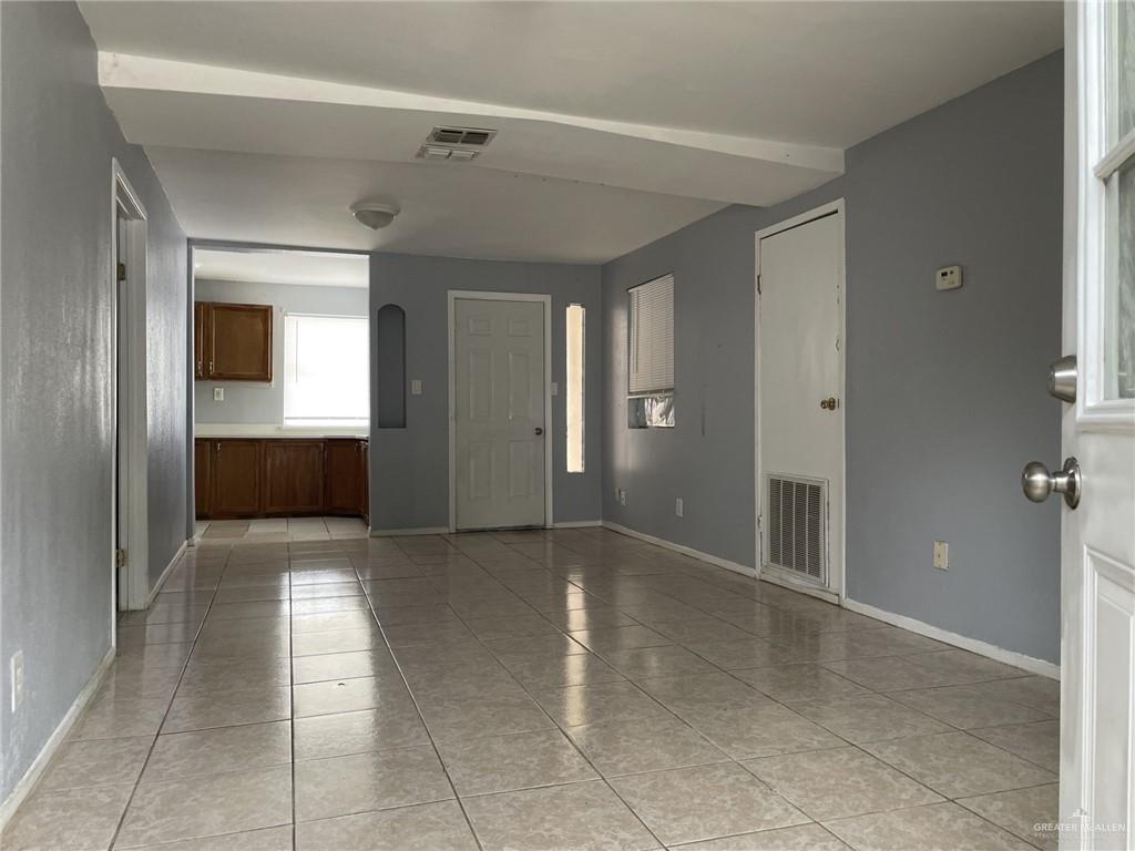 412 East 18th Street, Unit A Weslaco, TX 78596 - Photo 3 of 13 Living/dining area from front door with back door to patio at the end.