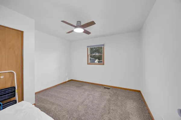 a view of a big room with wooden floor and closet