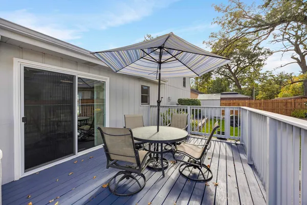 a view of a chair and table on the deck