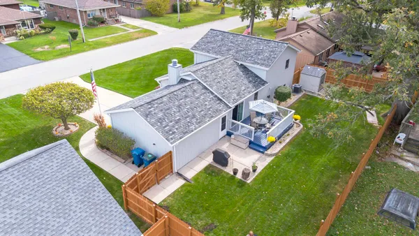 an aerial view of a house with garden space and street view