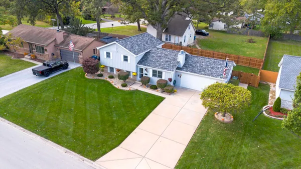an aerial view of houses with outdoor space