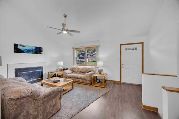 a living room with furniture a fireplace and a flat screen tv