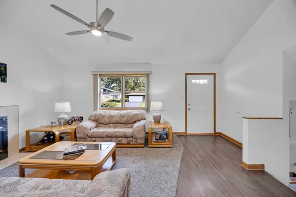 a living room with furniture and a wooden floor