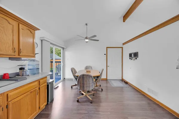 a view of a kitchen with dining table and chairs