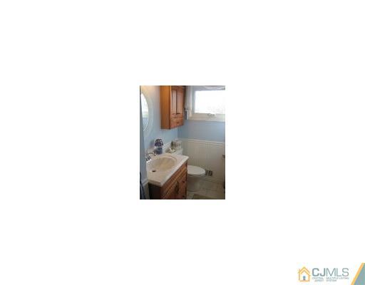 13 Lehigh Road Old Bridge, NJ 08859 - Photo 11 of 13 a bathroom with a sink and a mirror
