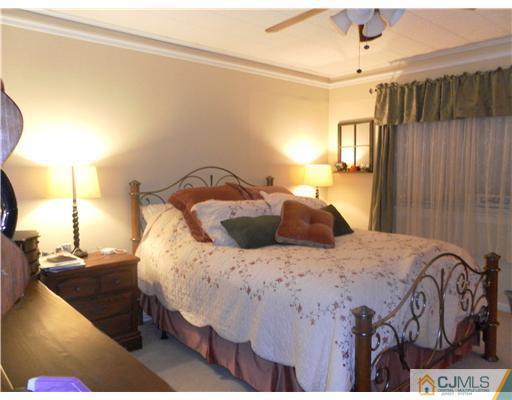 13 Lehigh Road Old Bridge, NJ 08859 - Photo 8 of 13 a bedroom with a bed a dresser with wooden floor