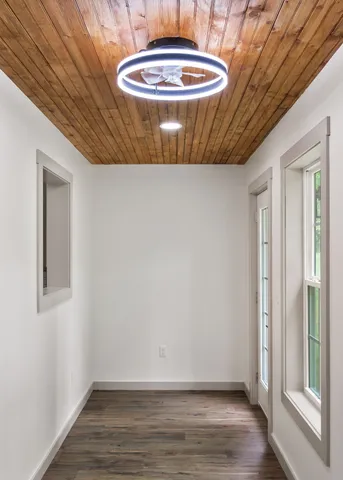 a view of empty room with wooden floor