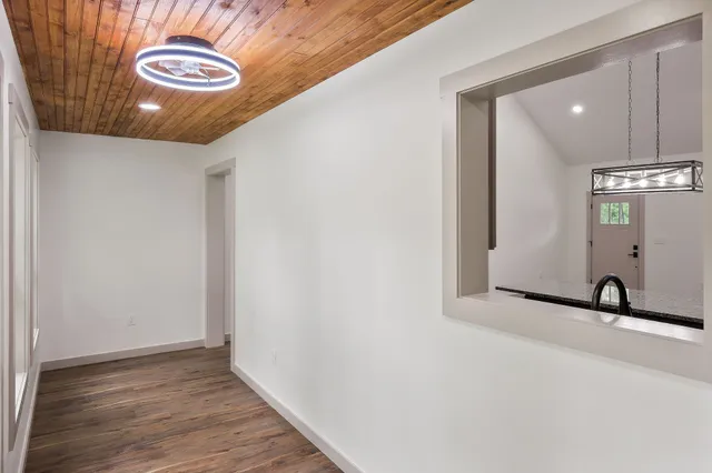 a view of a hallway with wooden floor