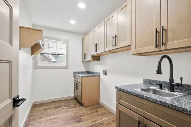 a kitchen with granite countertop a sink and cabinets