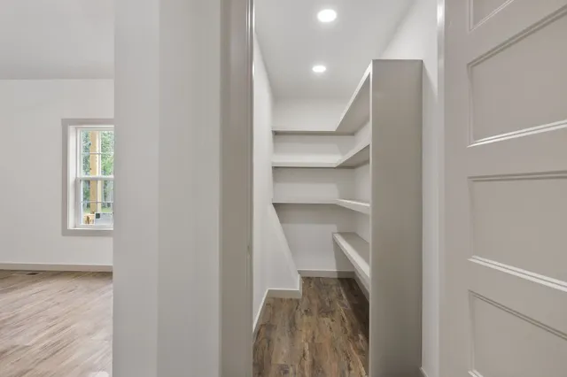 a view of walk in closet with empty racks