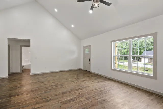 wooden floor in an empty room with a window