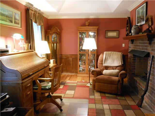 489 Pond Apple Road Clarksville, TN 37043 - Photo 12 of 17 This room could be used as a Library, Second Office or a Den. It features built-in bookcases, wood wainscoting, hardwood flooring, see-thru fireplace, and tray ceiling.
