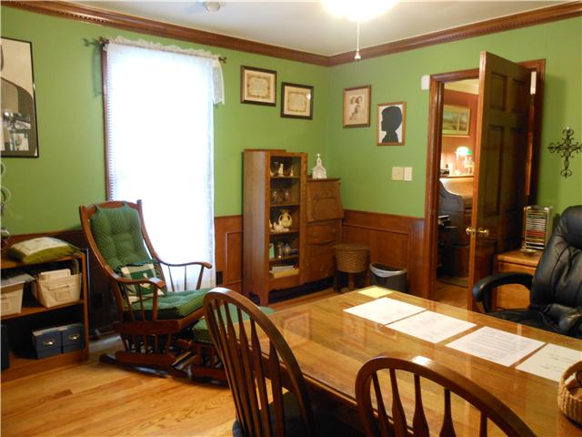 489 Pond Apple Road Clarksville, TN 37043 - Photo 13 of 17 The Office features a ceiling fan, hardwood flooring and wood wainscoting.