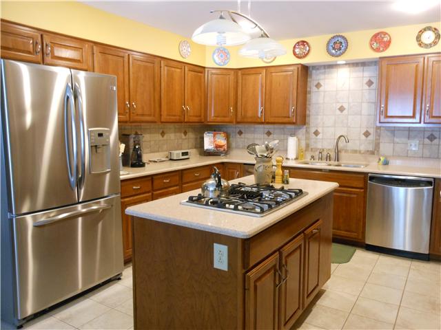 489 Pond Apple Road Clarksville, TN 37043 - Photo 3 of 17 Lots of counterspace and cabinets in this kitchen. GE Profile stainless steel appliances include: 3 door refrigerator, down-draft gas cooktop with grill and griddle, double oven, microwave and dishwasher. There is also a trash compactor.