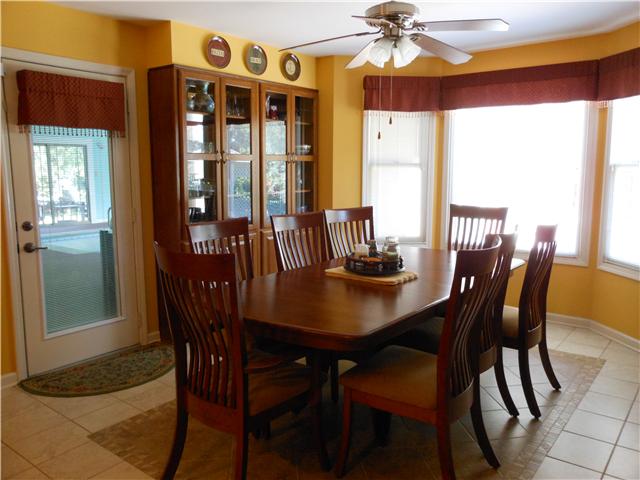489 Pond Apple Road Clarksville, TN 37043 - Photo 5 of 17 Eat-In Area features a decorative tile "rug" and built in glass door cabinets on each side.