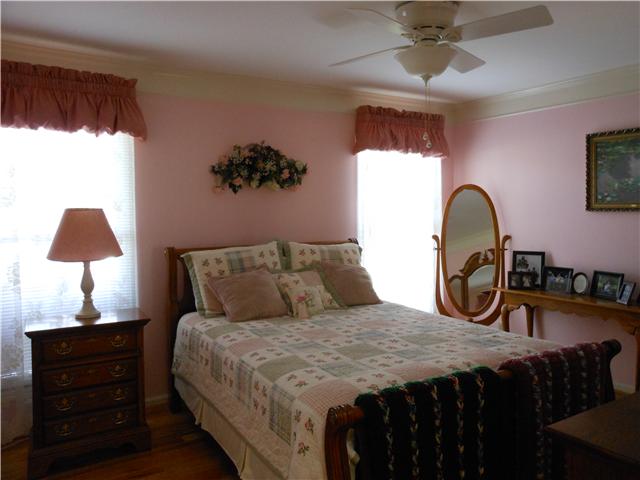 489 Pond Apple Road Clarksville, TN 37043 - Photo 10 of 17 Bedroom 1 features hardwood flooring and a ceiling fan.