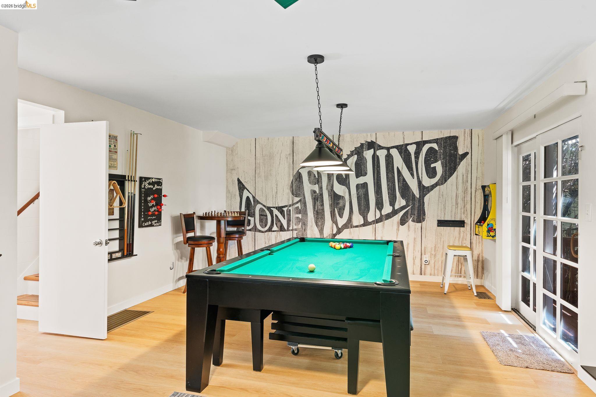 1704 Taylor Road Bethel Island, CA 94511 - Photo 13 of 73 Recreation room featuring wood-finish flooring, a decorative accent wall, recessed lighting, and French doors providing external access