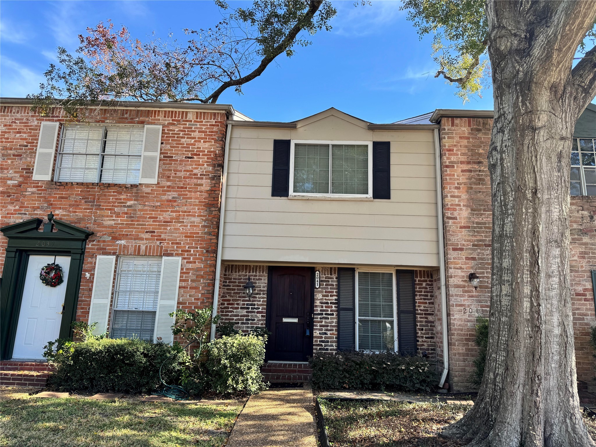 a front view of a house with a yard garage and outdoor seating