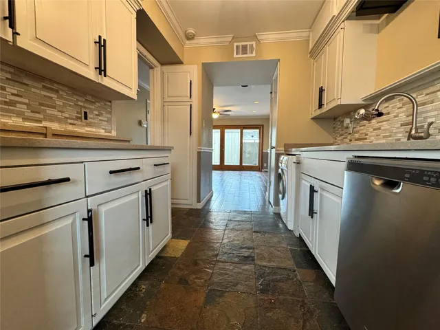 a kitchen with cabinets and window